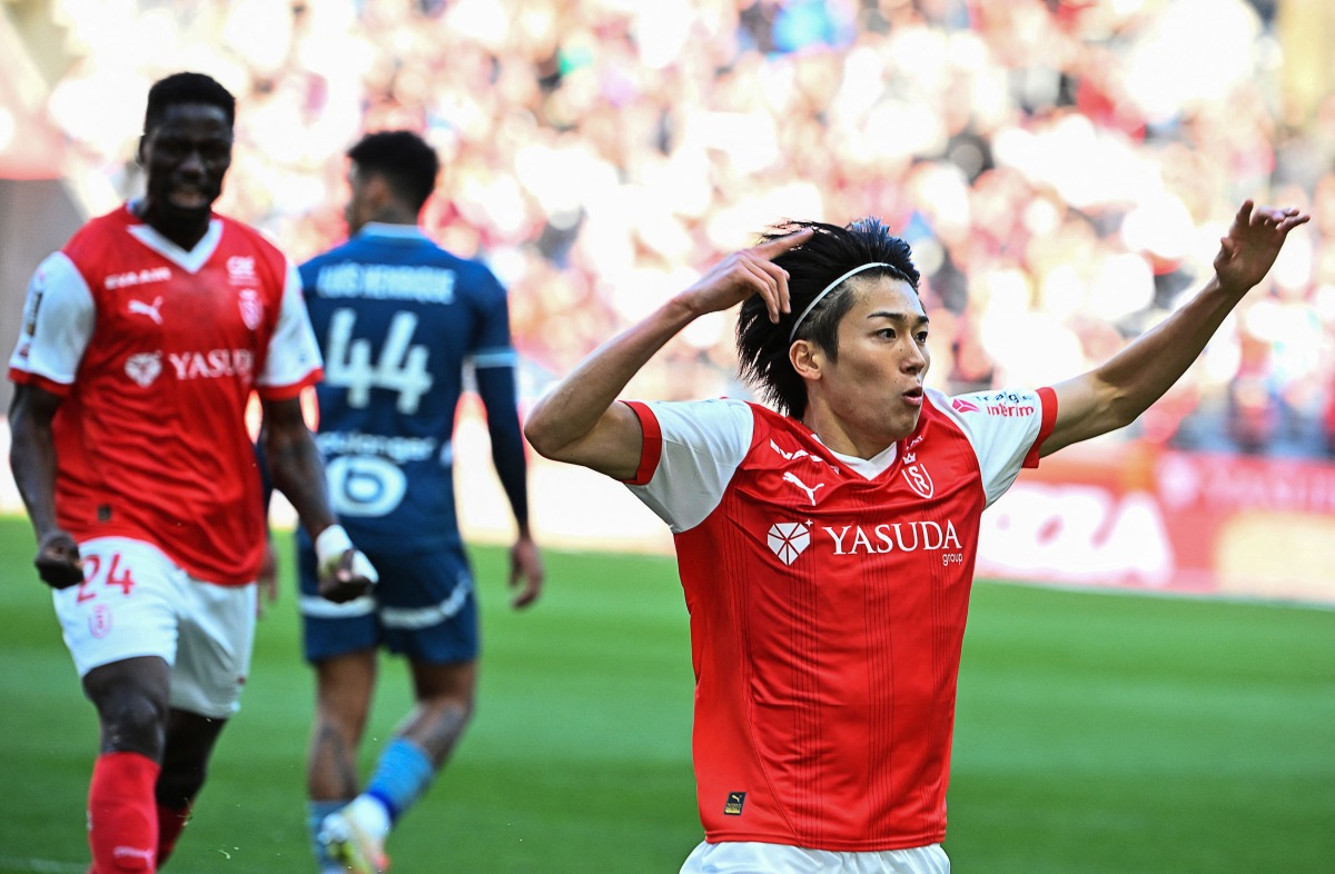 Reims' Japanese forward #17 Keito Nakamura celebrates after scoring the opening goal during the French L1 football match between Stade de Reims and Olympique de Marseille (OM) at Stade Auguste-Delaune in Reims, northern France on March 29, 2025. (Photo by FRANCOIS NASCIMBENI / AFP)
