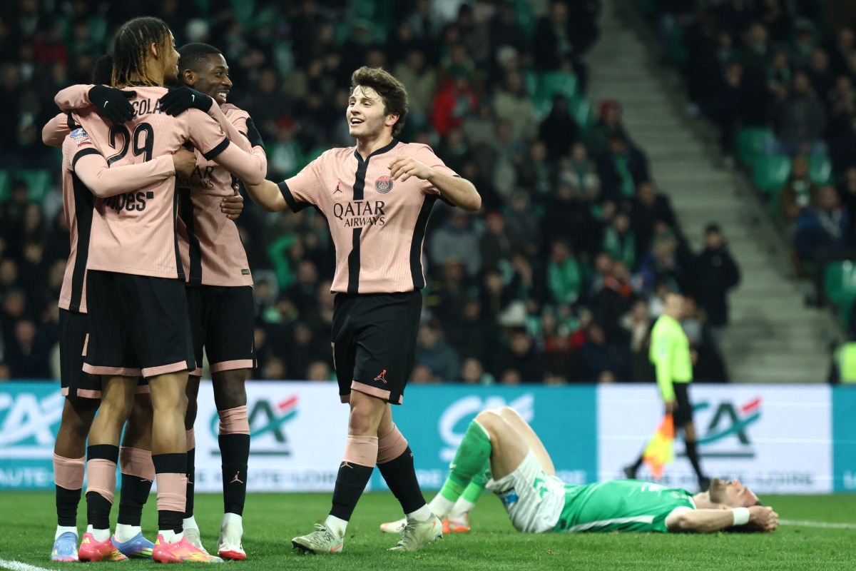 (from L) Paris Saint-Germain's French forward #29 Bradley Barcola, Paris Saint-Germain's French forward #10 Ousmane Dembele and Paris Saint-Germain's Portuguese midfielder #87 Joao Neves celebrate their sixth goal during the French L1 football match between AS Saint-Etienne and Paris Saint-Germain (PSG) at the Geoffroy-Guichard stadium in Saint-Etienne, central France on March 29, 2025. (Photo by Alex MARTIN / AFP)
