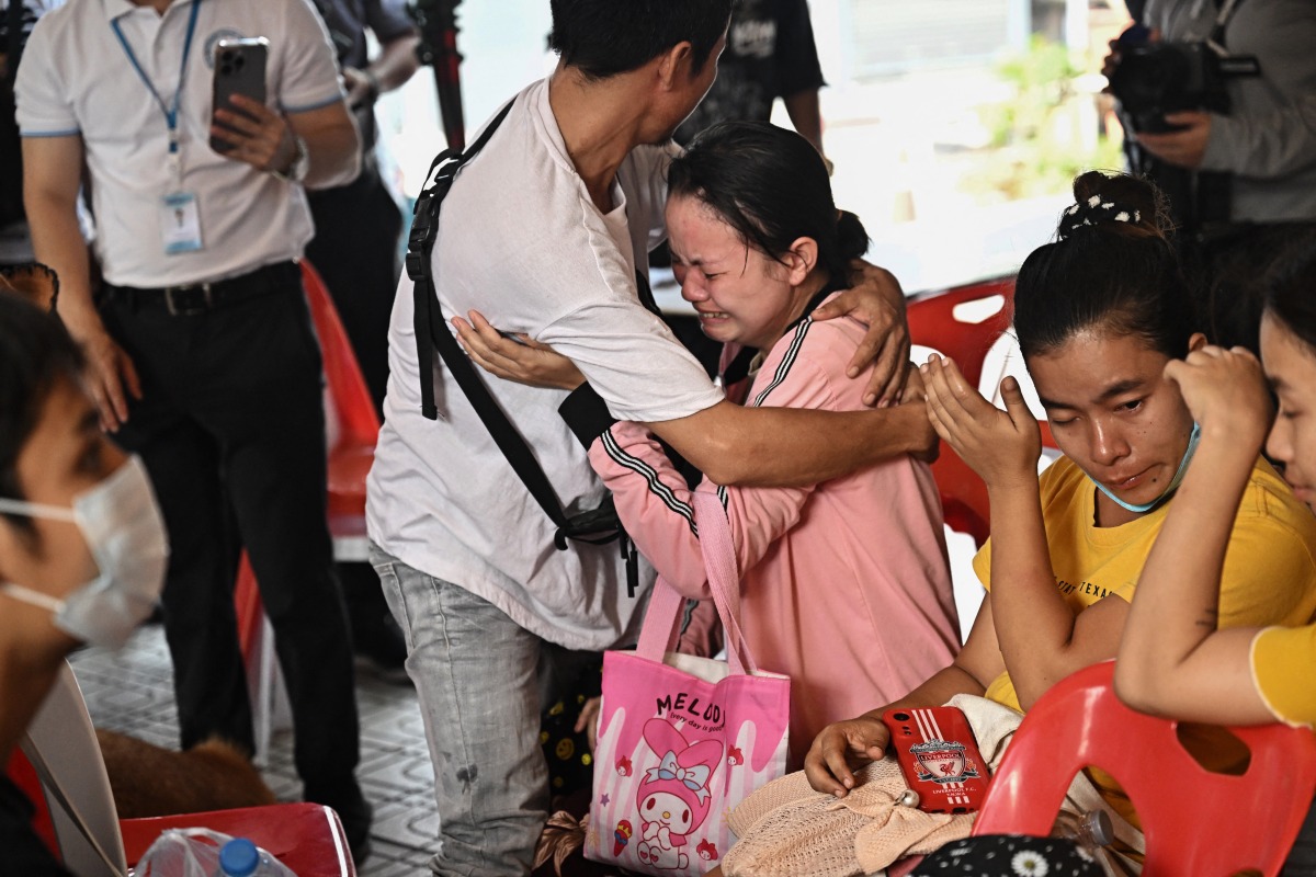 Photo used for representational purposes. People react while waiting for news of missing loved ones at the site of an under-construction building collapse in Bangkok on April 1, 2025, four days after an earthquake struck central Myanmar and Thailand. Photo by Lillian SUWANRUMPHA / AFP.