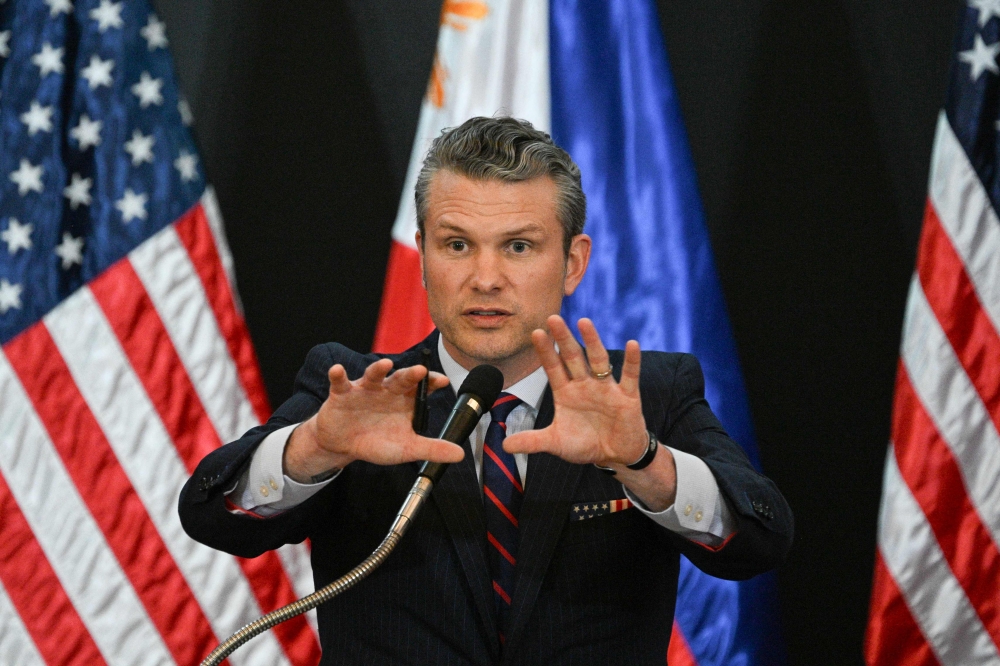 US Secretary of Defense Pete Hegseth gestures during a joint press conference with Philippines' Secretary of National Defense Gilberto Teodoro after their meeting at Camp Aguinaldo in Manila on March 28, 2025. (Photo by Ted Aljibe / AFP)