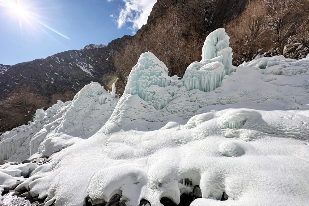 This photograph taken on March 18, 2025 shows an artificial glacier built by local residents during winters to conserve water for the summers at Pari village in Kharmang district, in Pakistan's mountainous Gilgit-Baltistan region. (Photo by Manzoor Balti / AFP)