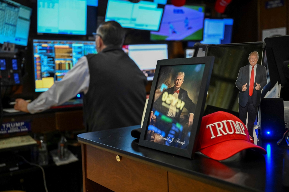 A trader works on the floor of the New York Stock Exchange (NYSE) during afternoon trading on April 9, 2025 in New York. (Photo by Angela Weiss / AFP)