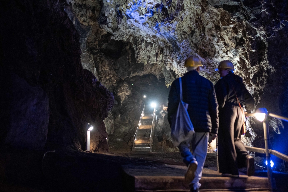 Wits University students walk up a flight of stairs at the Sterkfontein caves located within the Cradle of Humankind UNESCO World Heritage Site in Krugersdorp near Johannesburg on April 15, 2025. (Photo by Emmanuel Croset / AFP)