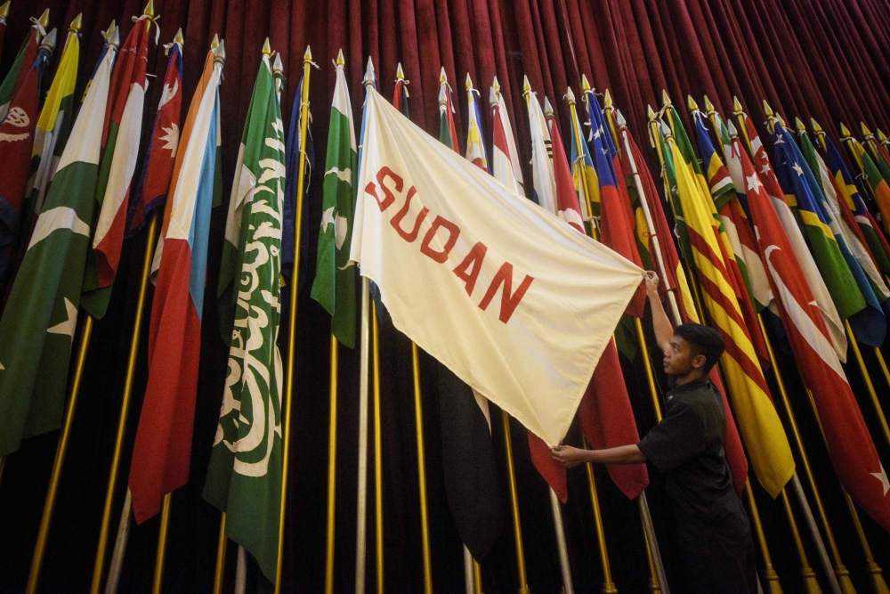 A security guard shows Sudan's national flag from that time in the main hall at the Museum of the Asian-African Conference, where the Conference was held from April 18 to 24, 1955, in Bandung, West Java on April 19, 2025, marking the 70th anniversary of the event. (Photo by Timur Matahari / AFP)