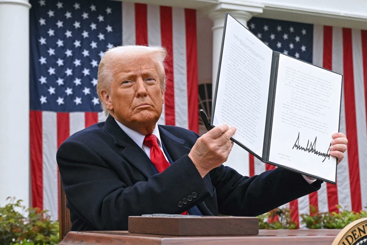 (FILES) US President Donald Trump holds a signed executive order after delivering remarks on reciprocal tariffs during an event in the Rose Garden entitled 