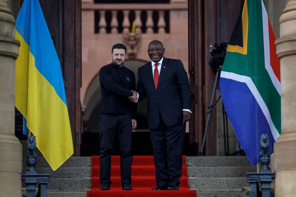 Ukraine's President Volodymyr Zelensky (left) is greeted by South Africa's President Cyril Ramaphosa during an official visit to South Africa, at the Union Buildings in Pretoria on April 24, 2024. (Photo by Phill Magakoe / AFP)