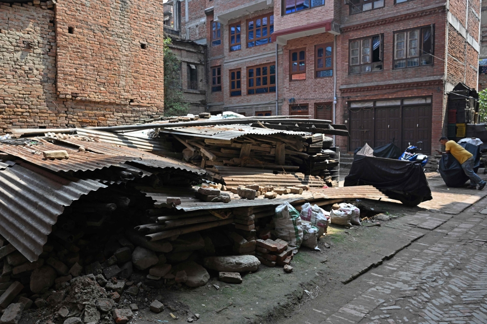 This photograph taken on April 16, 2025 shows remains of the 2015 earthquake, at a residential colony in Bhaktapur on the outskirts of Kathmandu. (Photo by Prakash Mathema / AFP) 