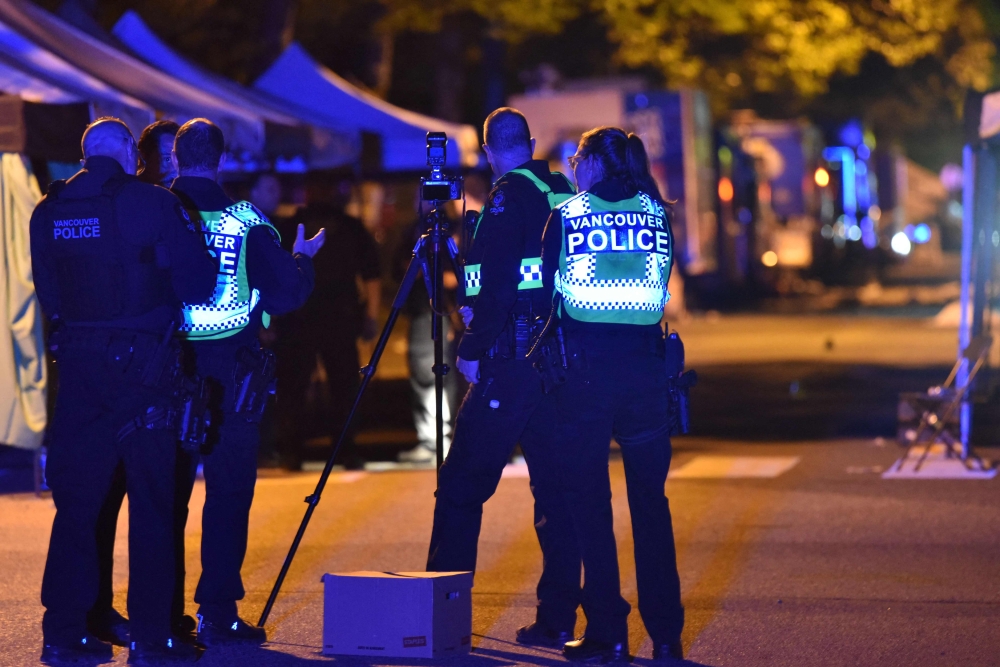 Vancouver police investigate a crime scene after a man drove into pedestrians at the annual Lapu Lapu festival celebrating Filipino culture, at East 43rd Avenue and Fraser, in the south of Vancouver on April 26, 2025. (Photo by Don MacKinnon / AFP)