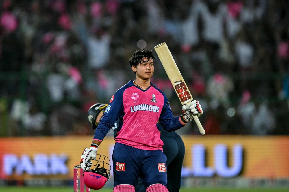 Rajasthan Royals' Vaibhav Suryavanshi celebrates after scoring a century (100 runs) during the Indian Premier League (IPL) Twenty20 cricket match in Jaipur on April 28, 2025. (Photo by Sajjad Hussain / AFP) 
