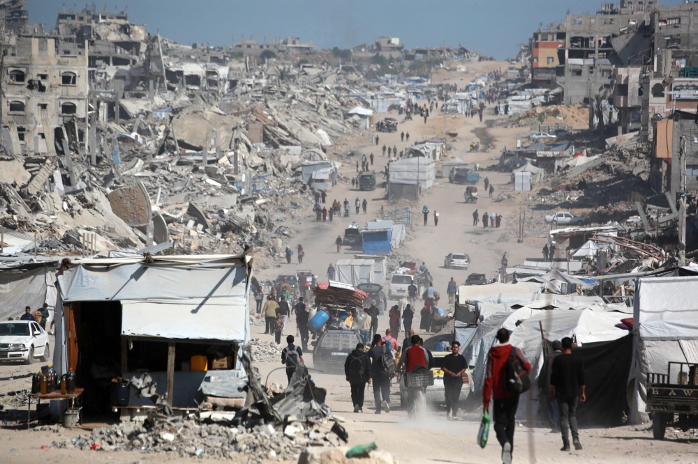 Palestinians carry their belongings as they flee Gaza City on May 16, 2025. (Photo by Bashar Taleb / AFP)
