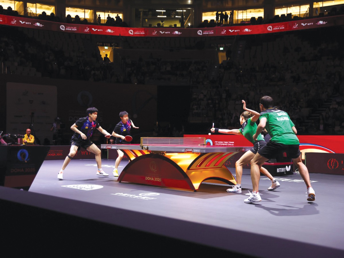 China's Wang Chuqin (left) and Sun Yingsha (second left) compete against Hugo Calderano and Bruna Takahashi of Brazil.