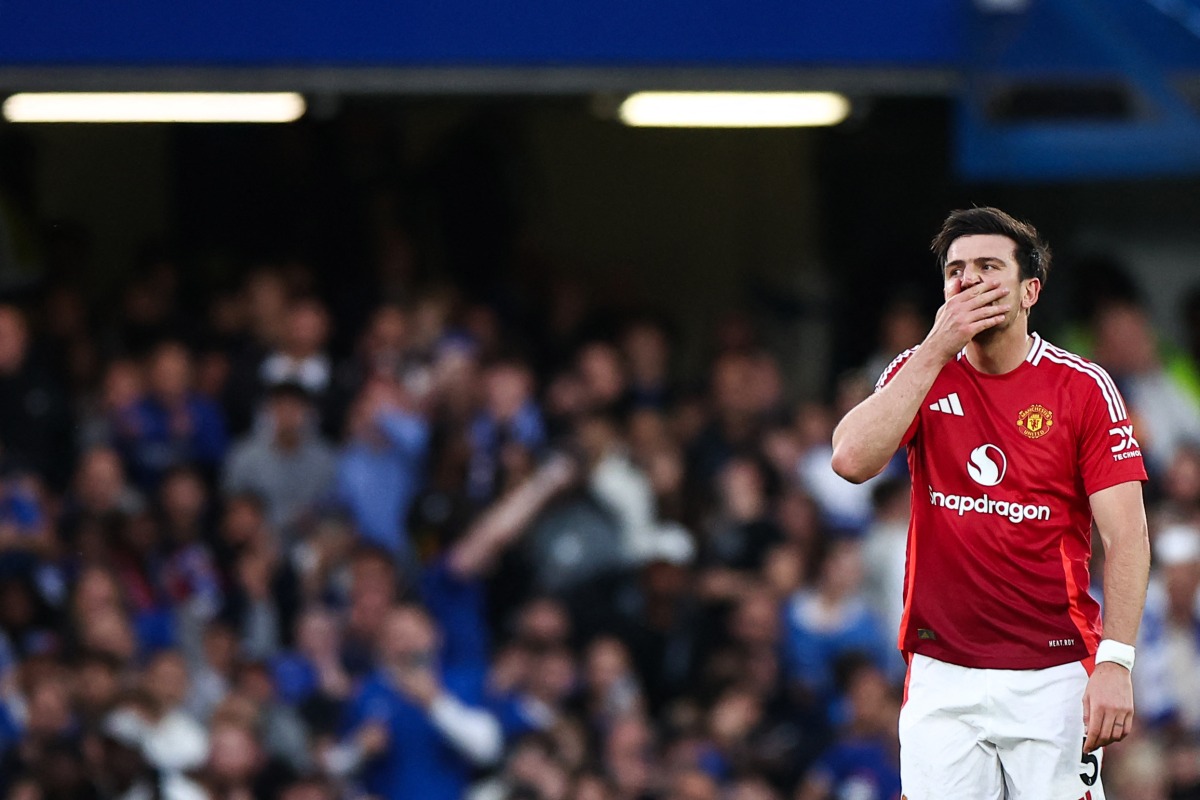 Manchester United's English defender #05 Harry Maguire celebrates after scoring a goal that is disallowed due to an offside position during the English Premier League football match between Chelsea and Manchester United at Stamford Bridge in London on May 16, 2025. (Photo by HENRY NICHOLLS / AFP)