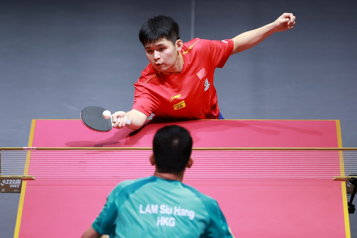 China's Lin Shidong hits a return during the men’s singles round of 64 match against Lam Siu Hang. Pictures: Xinhua