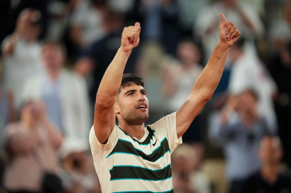 Spain's Carlos Alcaraz celebrates after winning his men's singles match against Bosnia and Herzegovina's Damir Dzumhur on Court Philippe-Chatrier at the Roland-Garros Complex in Paris on May 30, 2025. (Photo by Dimitar Dilkoff / AFP)