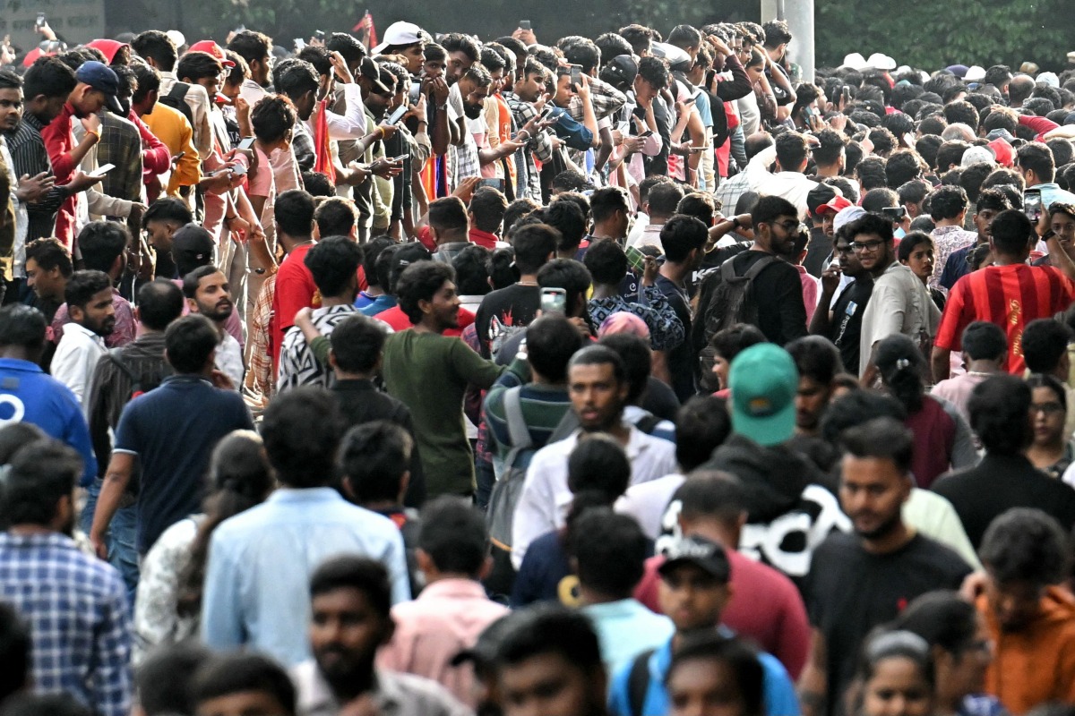 Fans gather to greet the players of Royal Challengers Bengaluru (RCB) after their victory in Indian Premier League (IPL) Twenty20 final cricket match, outside M.Chinnaswamy Stadium in Bengaluru on June 4, 2025. (Photo by Idrees MOHAMMED / AFP)