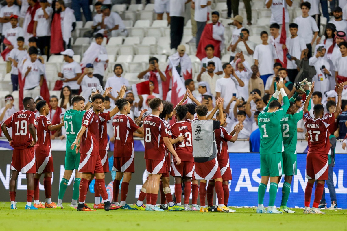 Qatar's players greet the fans after winning the 2026 FIFA World Cup Asian Qualifier football match between Qatar and Iran at Jassim Bin Hamad Stadium in Doha on June 5, 2025. (Photo by Karim JAAFAR / AFP)