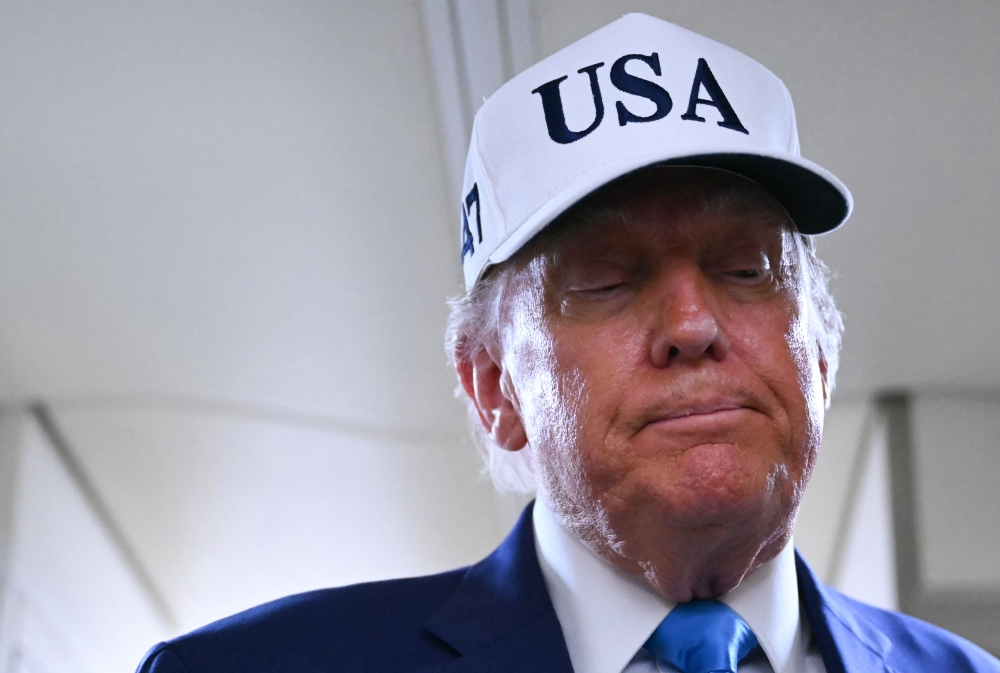 US President Donald Trump talks to the press aboard Air Force One on the way to Morristown Municipal Airport in Morristown, New Jersey, on June 6, 2025. (Photo by Andrew Caballero-Reynolds/ AFP)
