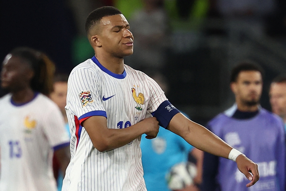 France's forward #10 Kylian Mbappe (C) and his teammates react after the UEFA Nations League semi-final football match between Spain and France in Stuttgart, southwestern Germany, on June 5, 2025. (Photo by Franck Fife / AFP) /