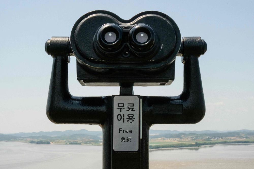 A pair of binoculars provided for visitors to watch the North Korean side of the Demilitarized Zone (DMZ) dividing the two Koreas, are seen at South Korea's Odusan Unification Observatory in Paju on June 12, 2025. (Photo by Anthony Wallace / AFP)
