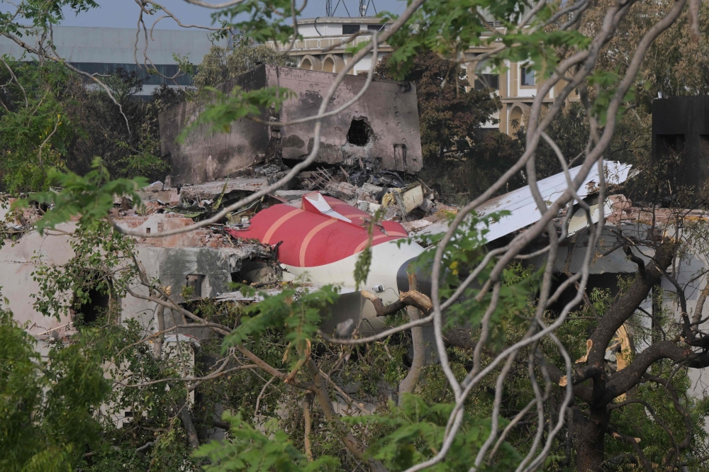 Wreckage showing the tail section of the Air India Boeing 787-8 is pictured in a residential area near the airport in Ahmedabad on June 14, 2025. (Photo by Dibyangshu Sarkar / AFP)