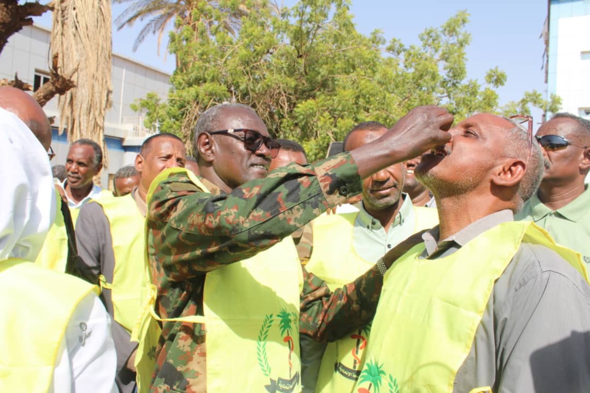 Khartoum State Governor Ahmed Osman Hamza (L, Front) administers the cholera vaccine to a man during a cholera vaccination campaign in Omdurman city, north of Khartoum, Sudan, on June 11, 2025. (Khartoum State Health Ministry/Handout via Xinhua)

