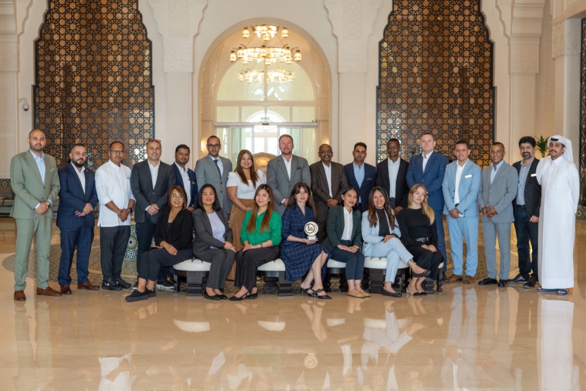 Hilton Salwa Beach Resort & Villas team with an award.