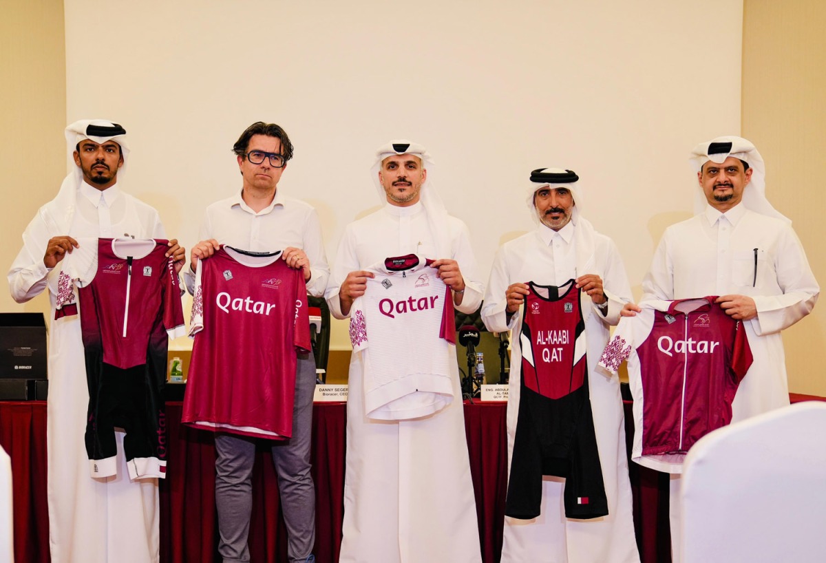 QCTF President Eng Abdulaziz Saud Al Tamimi (centre) and Bioracer CEO Danny Segers (second left) with other QCTF officials hold cycling gear delivered by Bioracer.