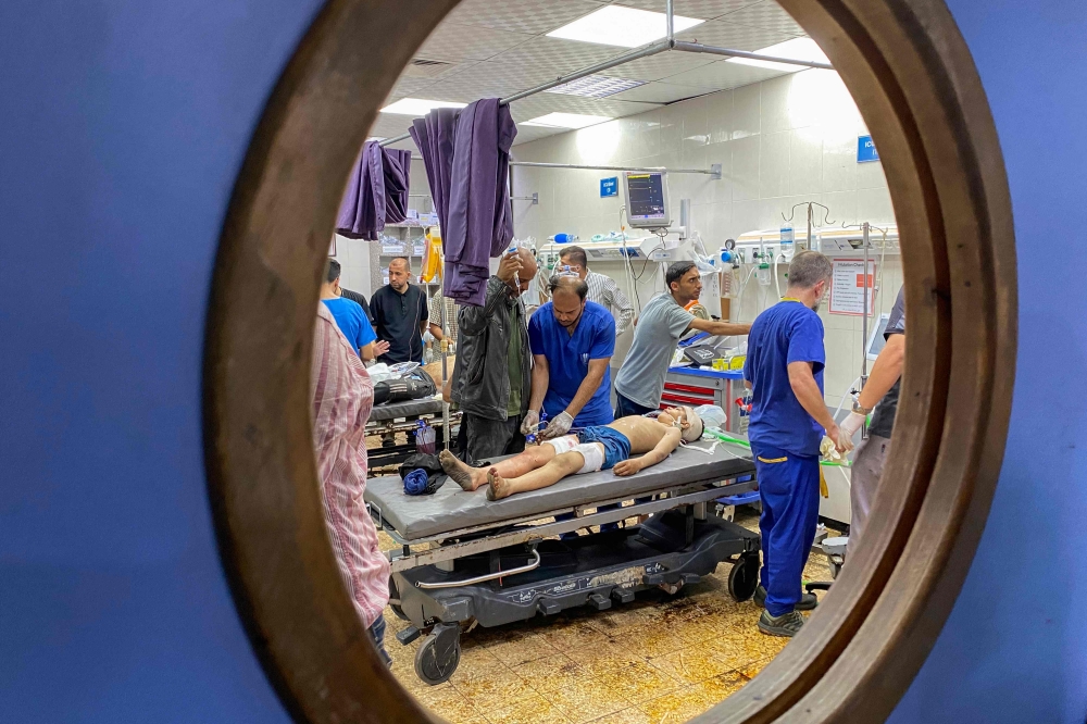 Palestinians who were injured in Israeli fire as they gathered near a food aid centre, receive care at Khan Yunis' Nasser hospital in the southern Gaza Strip on June 17, 2025. (Photo by AFP)