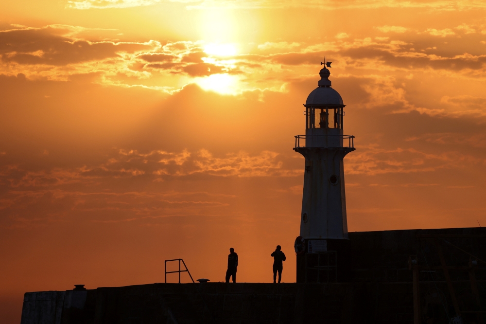 The sun rises at Mevagissey Harbour in Cornwall, Britain / Reuters file photo