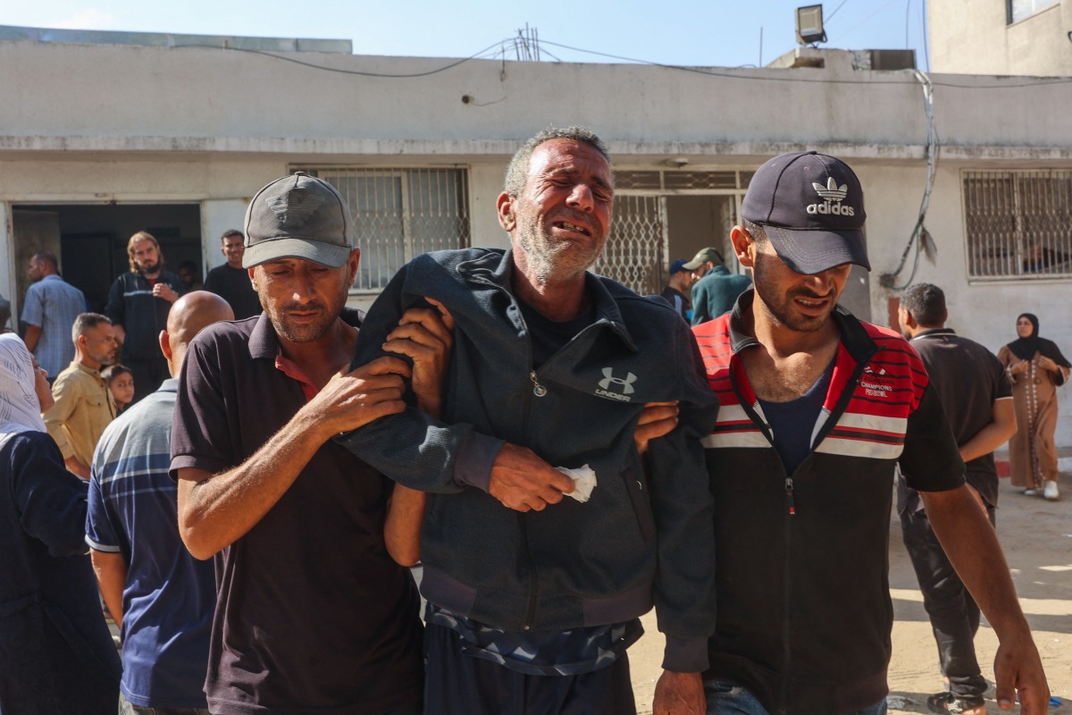 Relatives mourn Palestinians who were killed a day earlier in Israeli fire while seeking food aid, during his funeral at Al-Shifa hospital in Gaza City on June 18, 2025. Photo by Omar AL-QATTAA / AFP