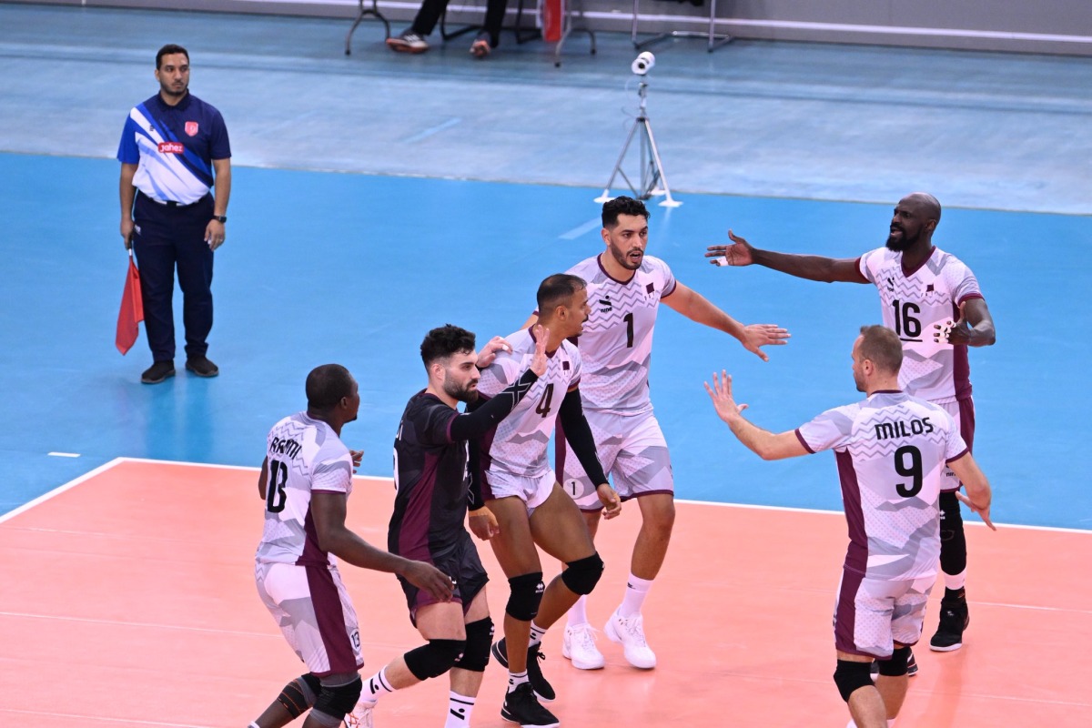 Qatar players celebrate a point against Vietnam.