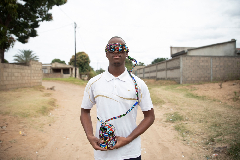 Robotics student and inventor Joao Antonio Rego (24) walks while wearing a smart glass prototype in Matola on June 14, 2025. (Photo by Amilton Neves / AFP)