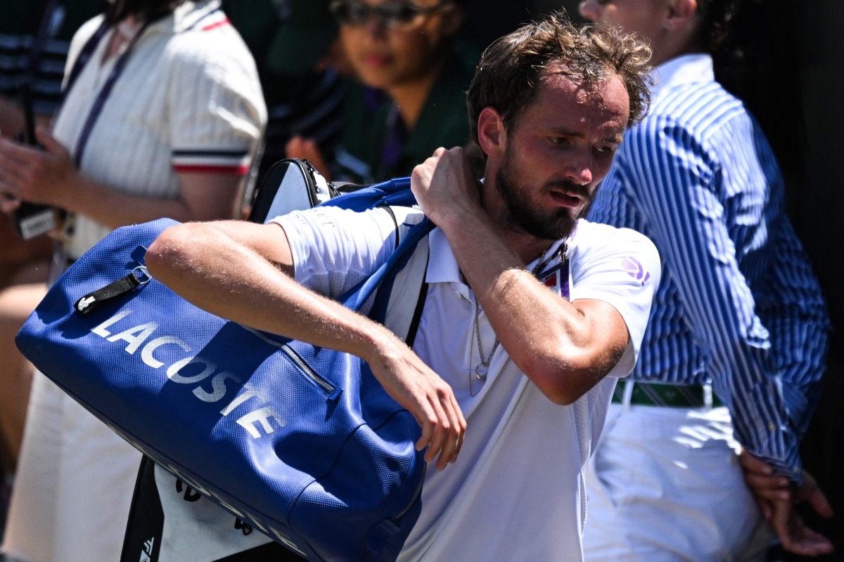 Russia's Daniil Medvedev leaves the court following his defeat against France's Benjamin Bonzi during their men's singles first round tennis match on the first day of the 2025 Wimbledon Championships at The All England Lawn Tennis and Croquet Club in Wimbledon, southwest London, on June 30, 2025. (Photo by Kirill KUDRYAVTSEV / AFP) 

