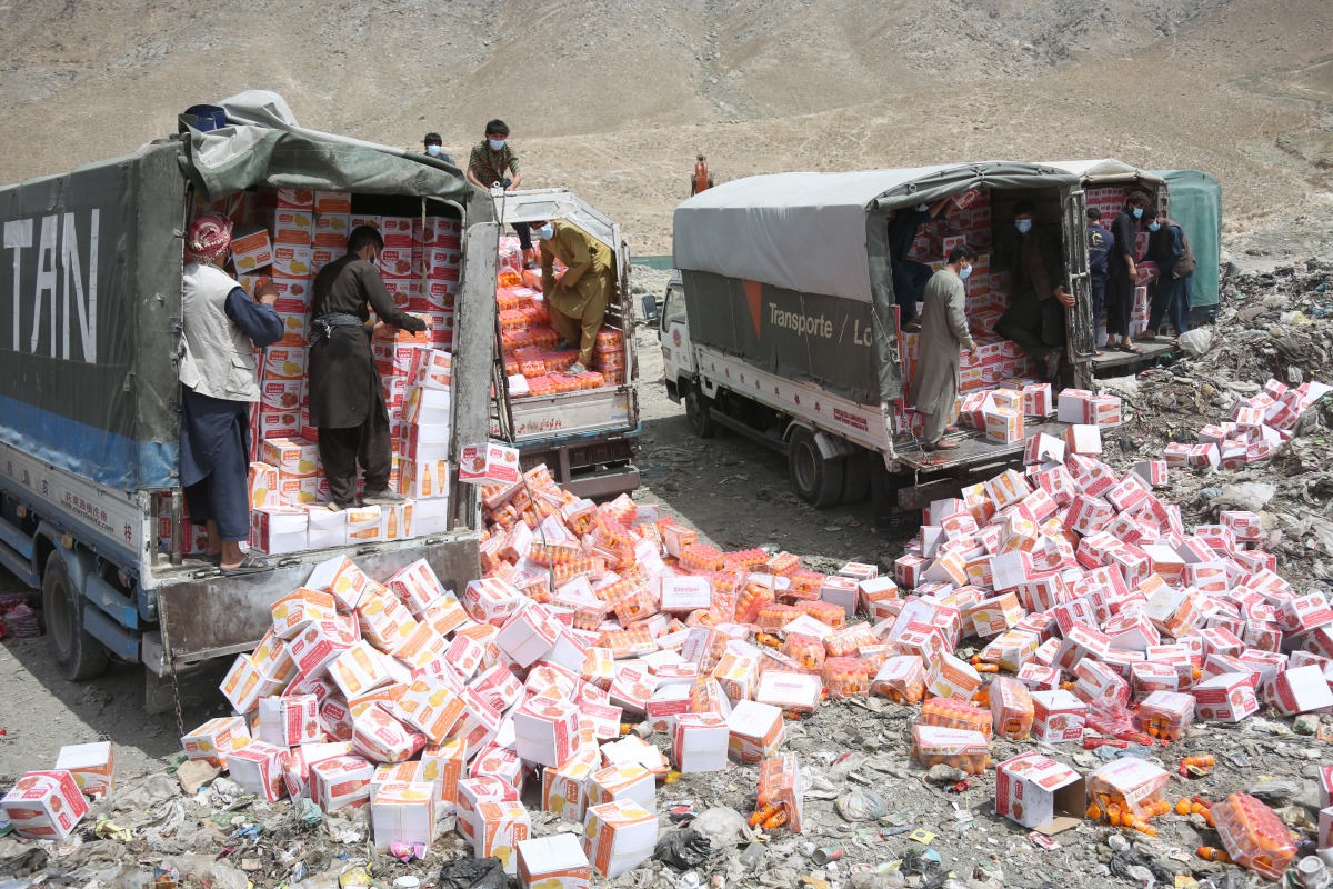 Workers unload expired and low-quality food items in Kabul, the capital of Afghanistan, July 15, 2025. (Photo by Saifurahman Safi/Xinhua)
