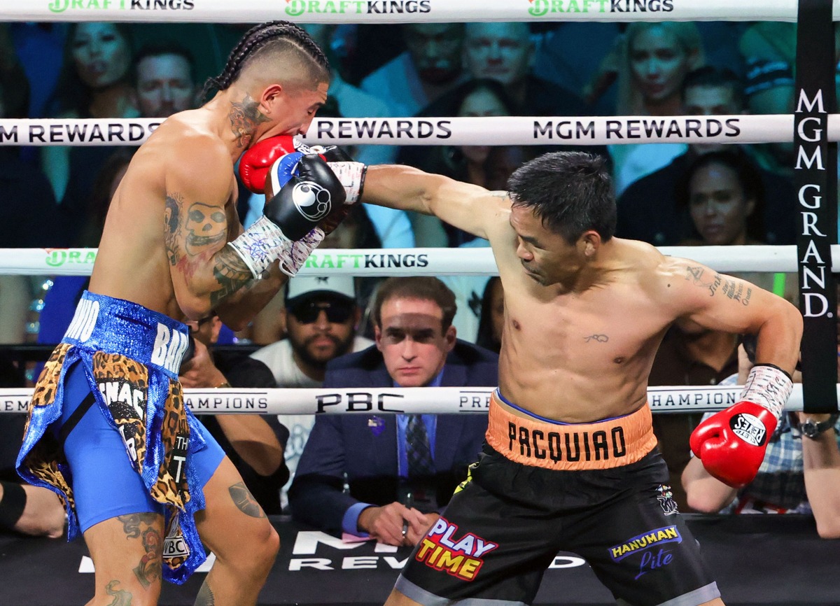 Manny Pacquiao (R) hits Mario Barrios in the first round of their WBC welterweight title fight at MGM Grand Garden Arena on July 19, 2025 in Las Vegas, Nevada. Photo by Ethan Miller / GETTY IMAGES NORTH AMERICA / Getty Images via AFP