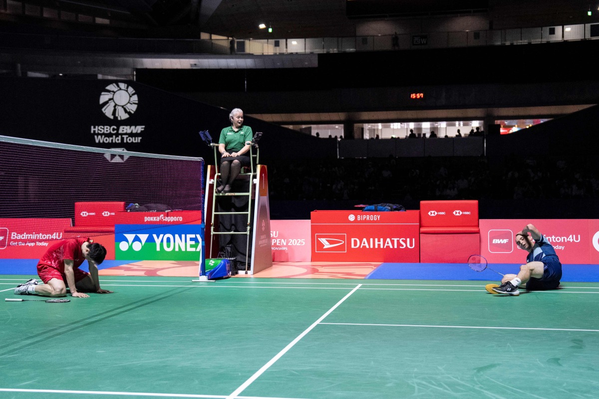 China's Shi Yuqi (L) and France's Alex Lanier react during their men's singles final match on the final day of the Japan Open badminton tournament at Tokyo Gymnasium in Tokyo on July 20, 2025. Photo by Yuichi YAMAZAKI / AFP