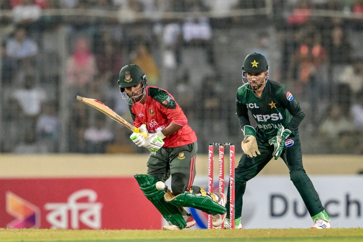 Bangladesh's Towhid Hridoy (L) plays a shot during the first Twenty20 international cricket match between Bangladesh and Pakistan at the Sher-e-Bangla National Cricket Stadium in Dhaka on July 20, 2025. (Photo by MUNIR UZ ZAMAN / AFP)
