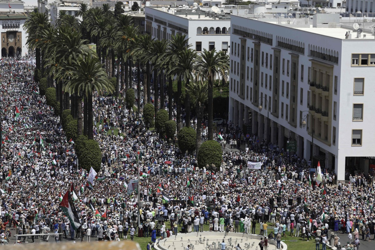 Moroccans wave Palestinian flags during a march to express their solidarity with the Palestinians in the Gaza Strip, in Rabat on July 19, 2025. (Photo by Abdel Majid BZIOUAT / AFP)
