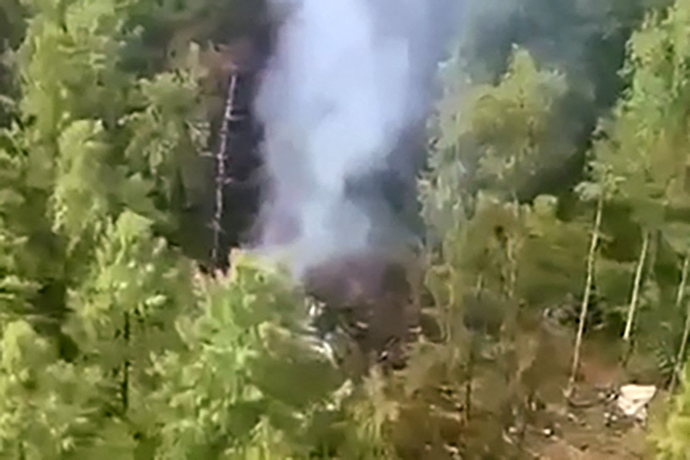 This video grab from a handout footage released by the Eastern Interregional Directorate for Transport of the Russian Investigative Committee on July 24, 2025, shows an aerial view of the crash site of the Antonov AN-24 passenger plane outside the town of Tynda in Russia's far eastern Amur region. Photo by Handout / Investigative Committee of Russia / AFP