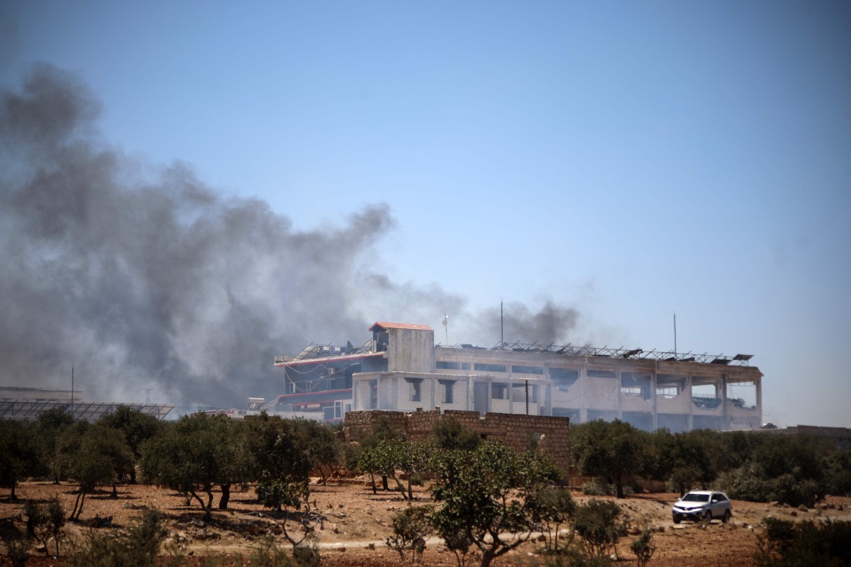 A plume of smoke rises following an explosion in Maarrat Misrin in the northern part of Syria's Idlib governorate on July 24, 2025. (Photo by Abdulaziz KETAZ / AFP)

