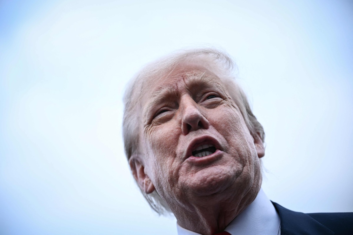 US President Donald Trump speaks to the press after disembarking from Air Force One upon his arrival at Prestwick Airport, south of Glasgow on July 25, 2025, on the first day of his UK visit. (Photo by Brendan SMIALOWSKI / AFP)
