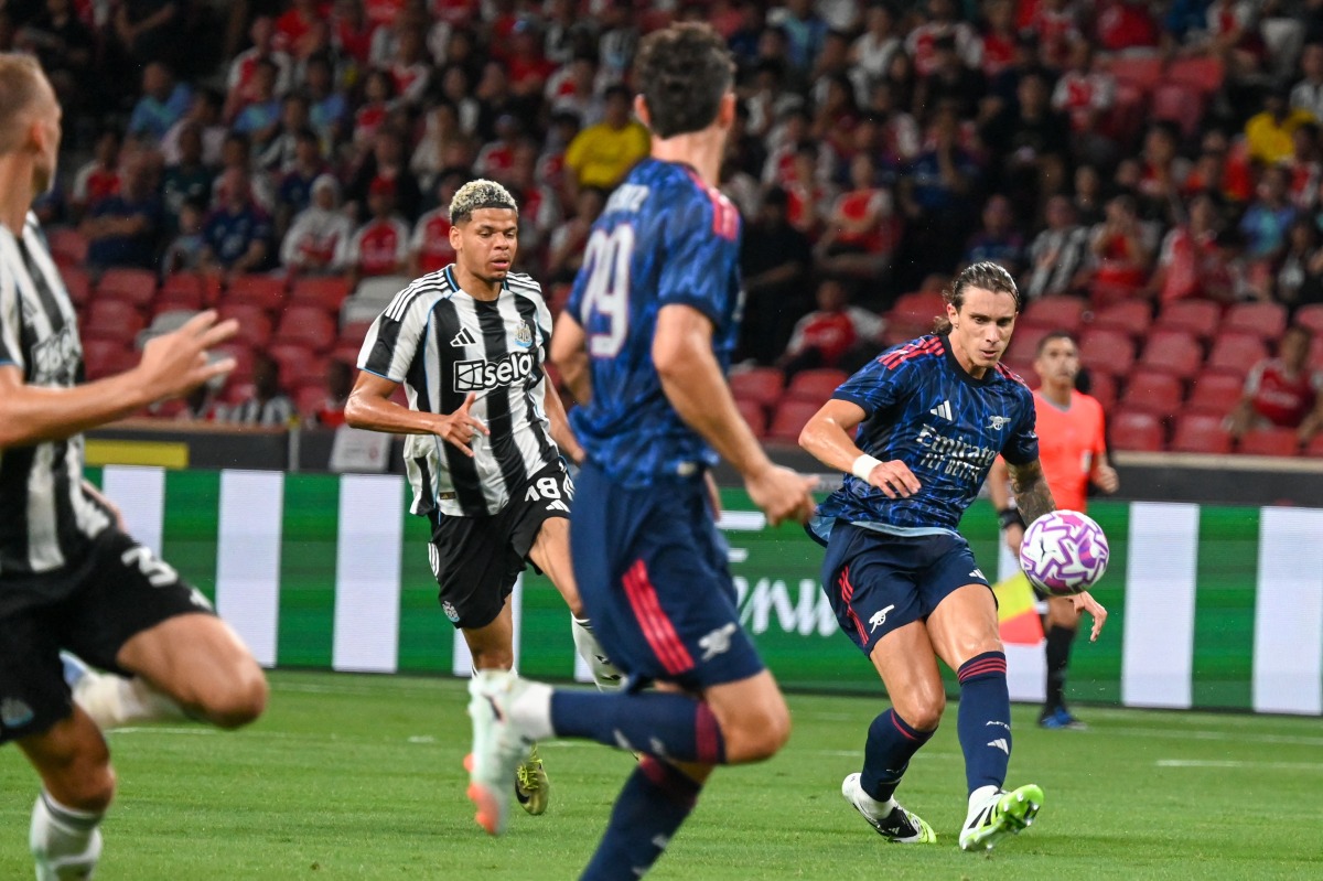 Arsenal's Riccardo Calafiori kicks the ball during the Singapore Festival of Football pre-season friendly match between Arsenal and Newcastle United at the National Stadium in Singapore on July 27, 2025. (Photo by Roslan RAHMAN / AFP)
