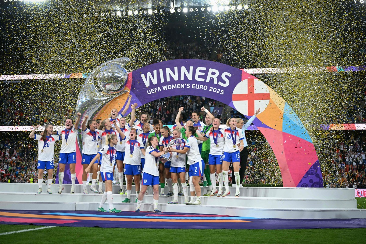 England's players lift the trophy as they celebrate winning the UEFA Women's Euro 2025 final football match between England and Spain at the St. Jakob-Park Stadium in Basel, on July 27, 2025. (Photo by SEBASTIEN BOZON / AFP)

