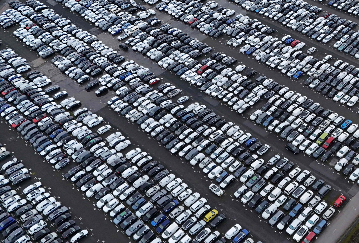 Aerial view shows new cars of various brands that are parked ready for sale at a car logistics terminal in Essen, western Germany, on November 22, 2024. Photo by Ina FASSBENDER / AFP