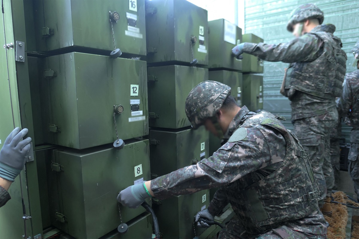 This handout photo taken on August 4, 2025 and provided by the South Korean Defence Ministry shows South Korean soldiers removing loudspeakers that were set up for propaganda broadcasts near the Demilitarized Zone separating the two Koreas in an undisclosed location in South Korea. Photo by Handout / South Korean Defence Ministry / AFP