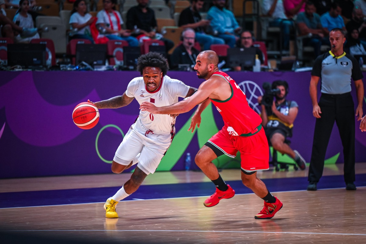 Qatar's Brandon Goodwin (left) in action during the match.