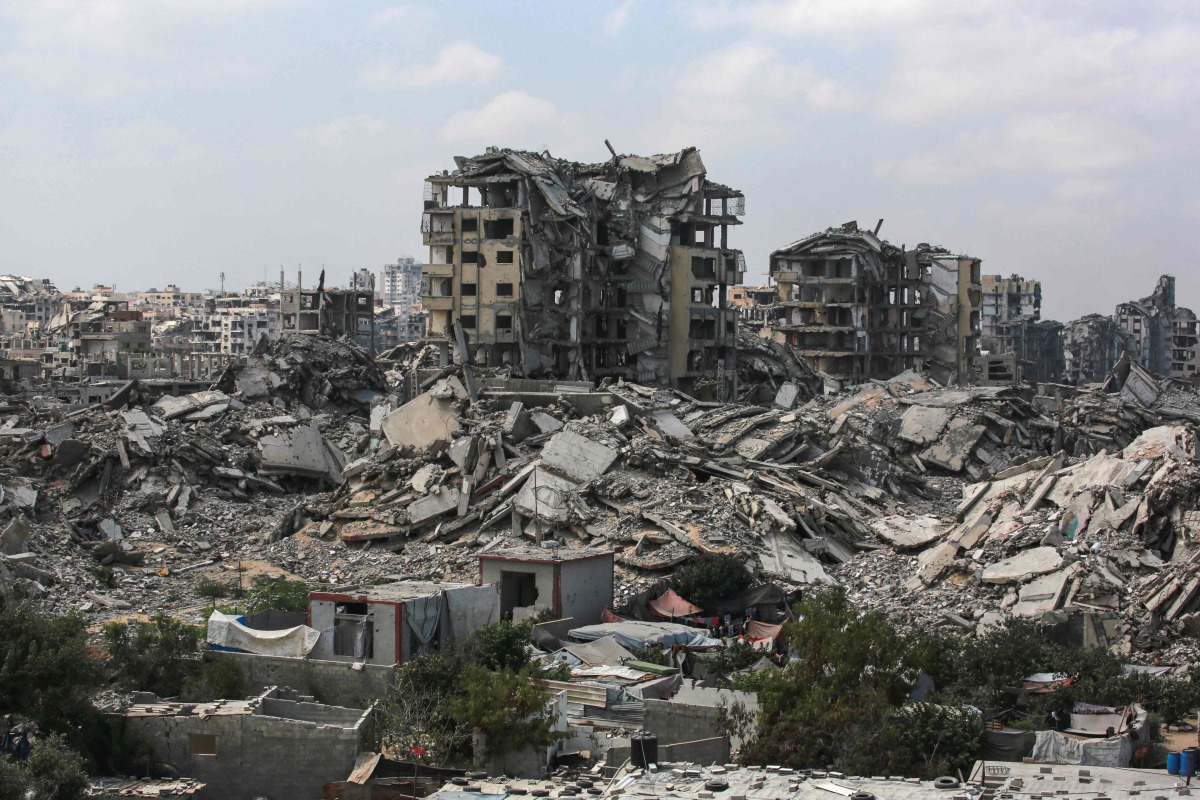 Buildings destroyed in Israeli strikes surround makeshift shelters for displaced Palestinians in Gaza City on August 8, 2025. (Photo by Bashar TALEB / AFP)
