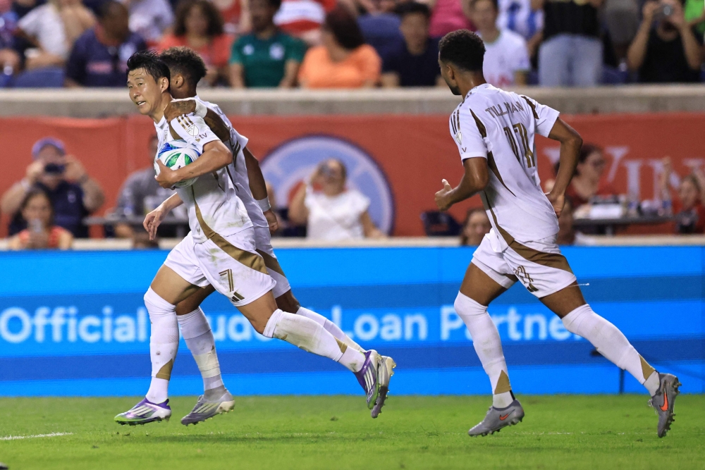 Son Heung-Min #7 of Los Angeles FC and teammate Timothy Tillman #11 celebrates after the team's second goal during the MLS match between Chicago Fire FC and Los Angeles Football Club at SeatGeek Stadium on August 09, 2025 in Bridgeview, Illinois. Geoff Stellfox/Getty Images/AFP 