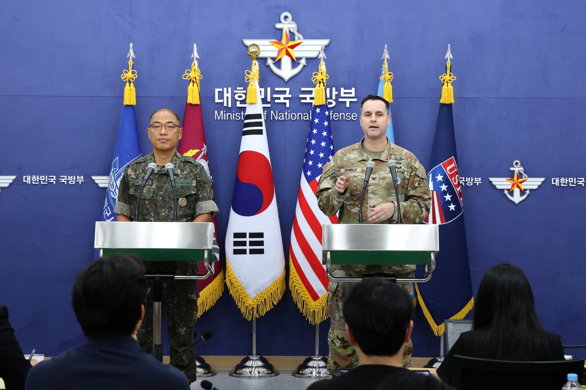 Col. Lee Sung-jun (L), public affairs director for South Korea's Joint Chiefs of Staff and Col. Ryan Donald, public affairs director of the United Nations Command (UNC), Combined Forces Command (CFC), and United States Forces Korea (USFK), attend the press briefing of the Ulchi Freedom Shield 2025 exercise at the Defense Ministry in Seoul on August 07, 2025. (Photo by Chung Sung-Jun / POOL / AFP)

