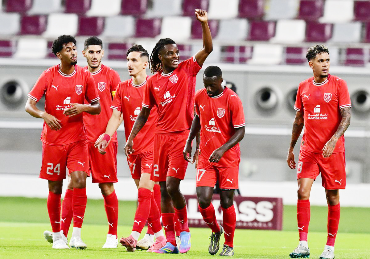 Al Duhail’s Ibrahima Bamba raises his hand in celebration after scoring the equaliser, joined by his teammates. PIC: AFC